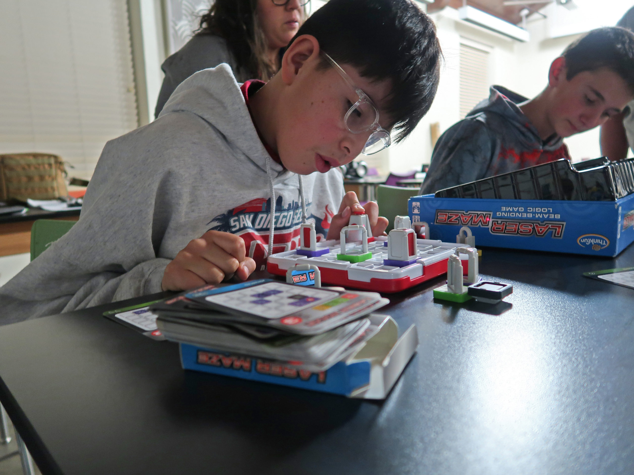 Students use a laser maze kit to direct a beam of light towards a target