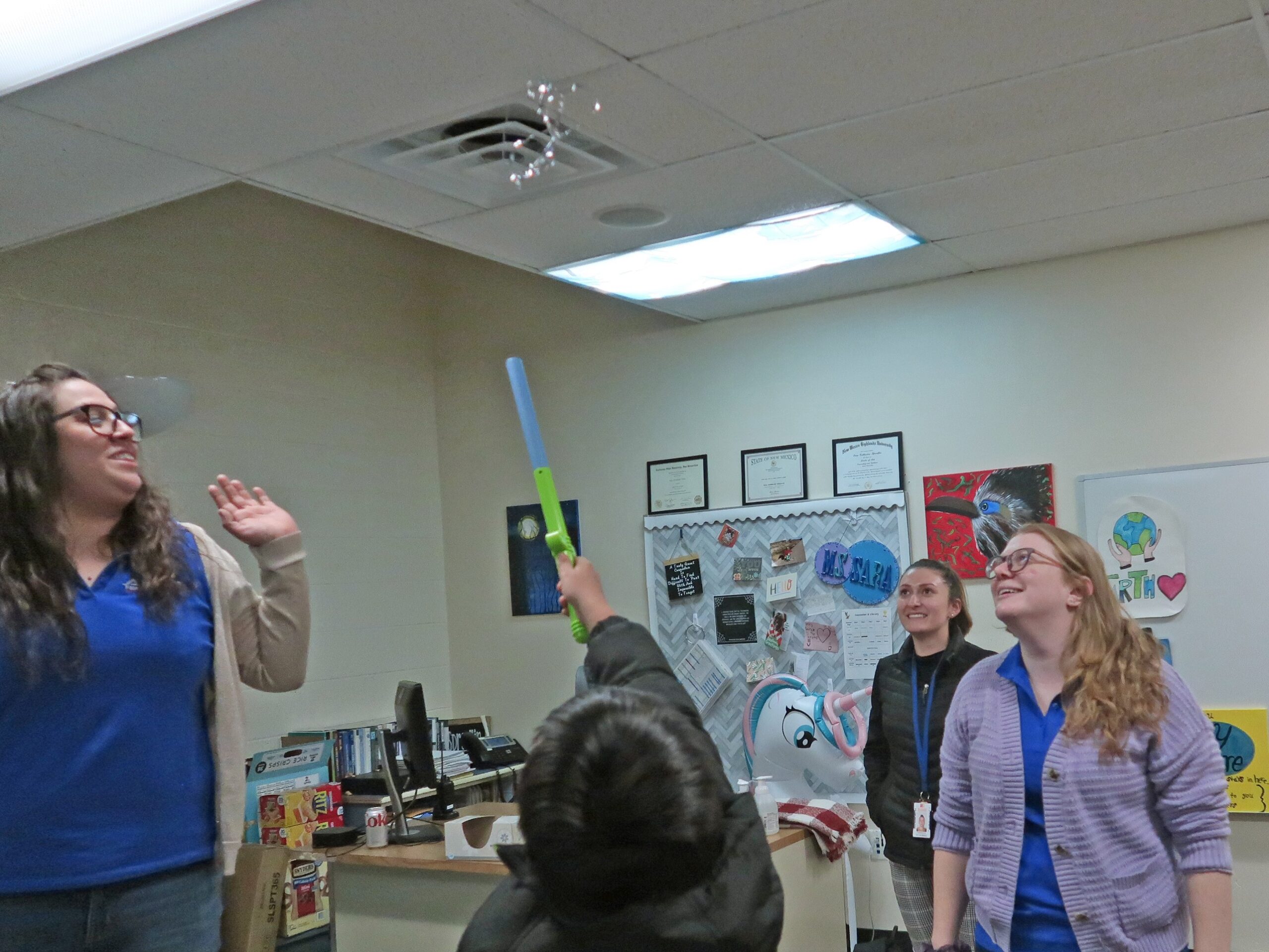 A student uses the Fun Flyer wand to levitate a small piece of mylar