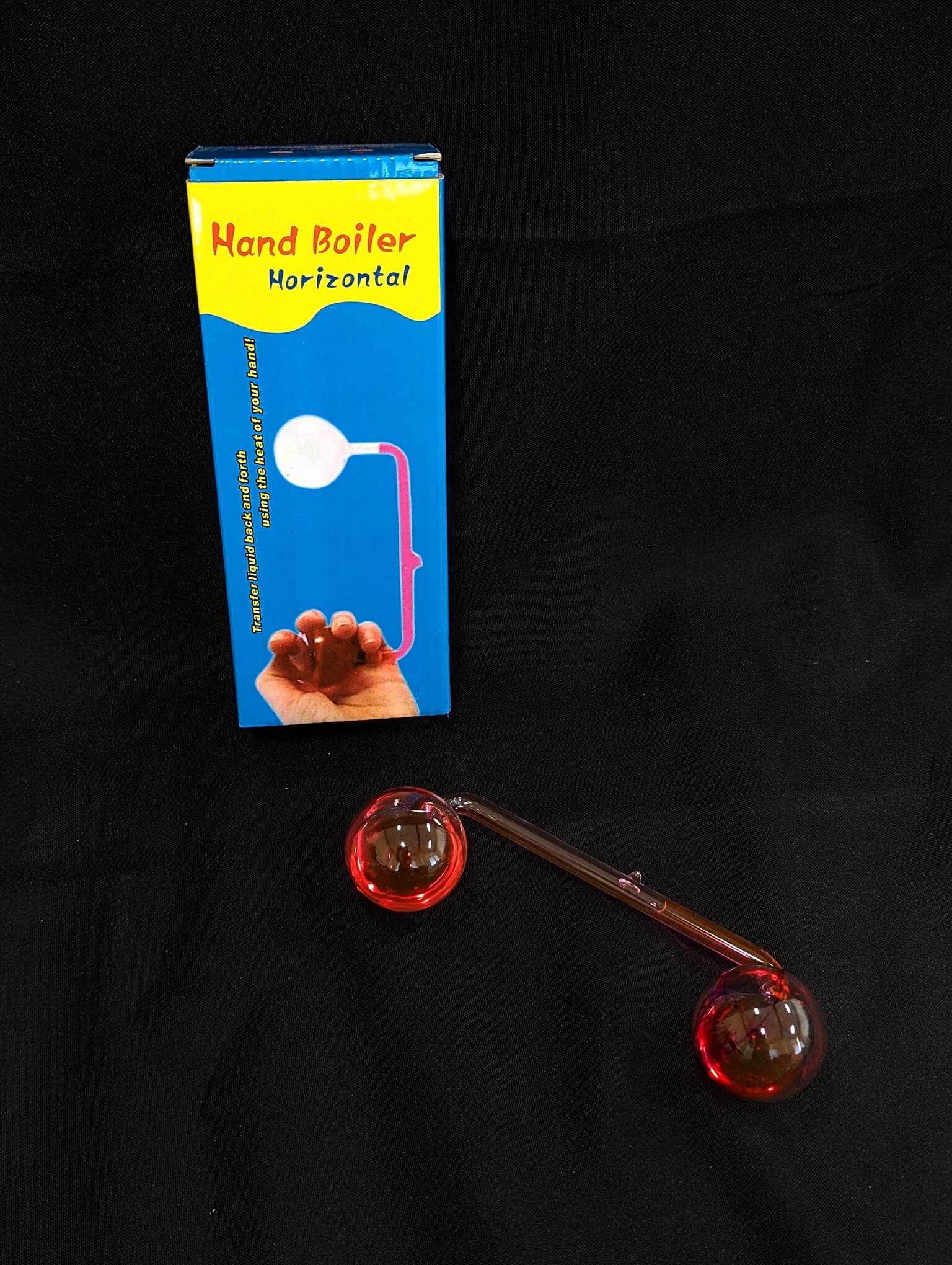 A box labeled Hand Boiler with a glass device filled with liquid